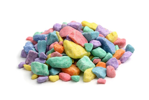 Pile of colored decorative gravel isolated on white